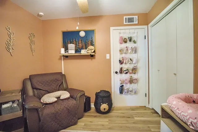 a bedroom with a couch and a chair in it