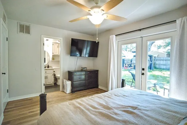 a bedroom with furniture and a flat screen tv