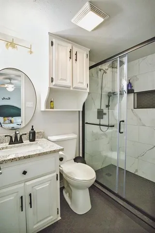 a bathroom with a sink toilet and shower