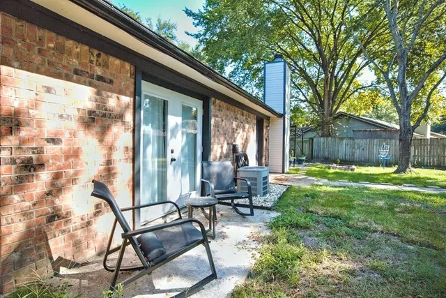 a swimming pool with outdoor seating and yard