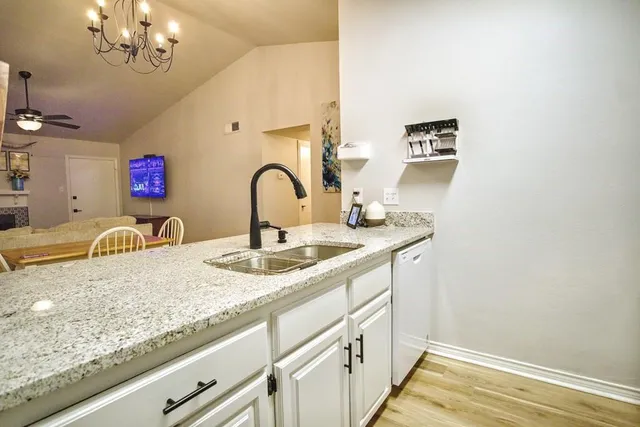 a bathroom with a granite countertop sink a mirror and vanity
