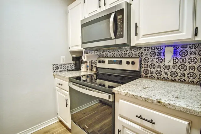 a stove top oven sitting inside of a kitchen