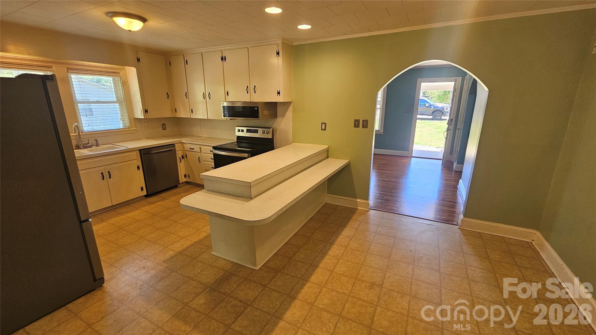 130 Pine State Road Troutman, NC 28166 - Photo 13 of 21 a kitchen with a sink a refrigerator and cabinets