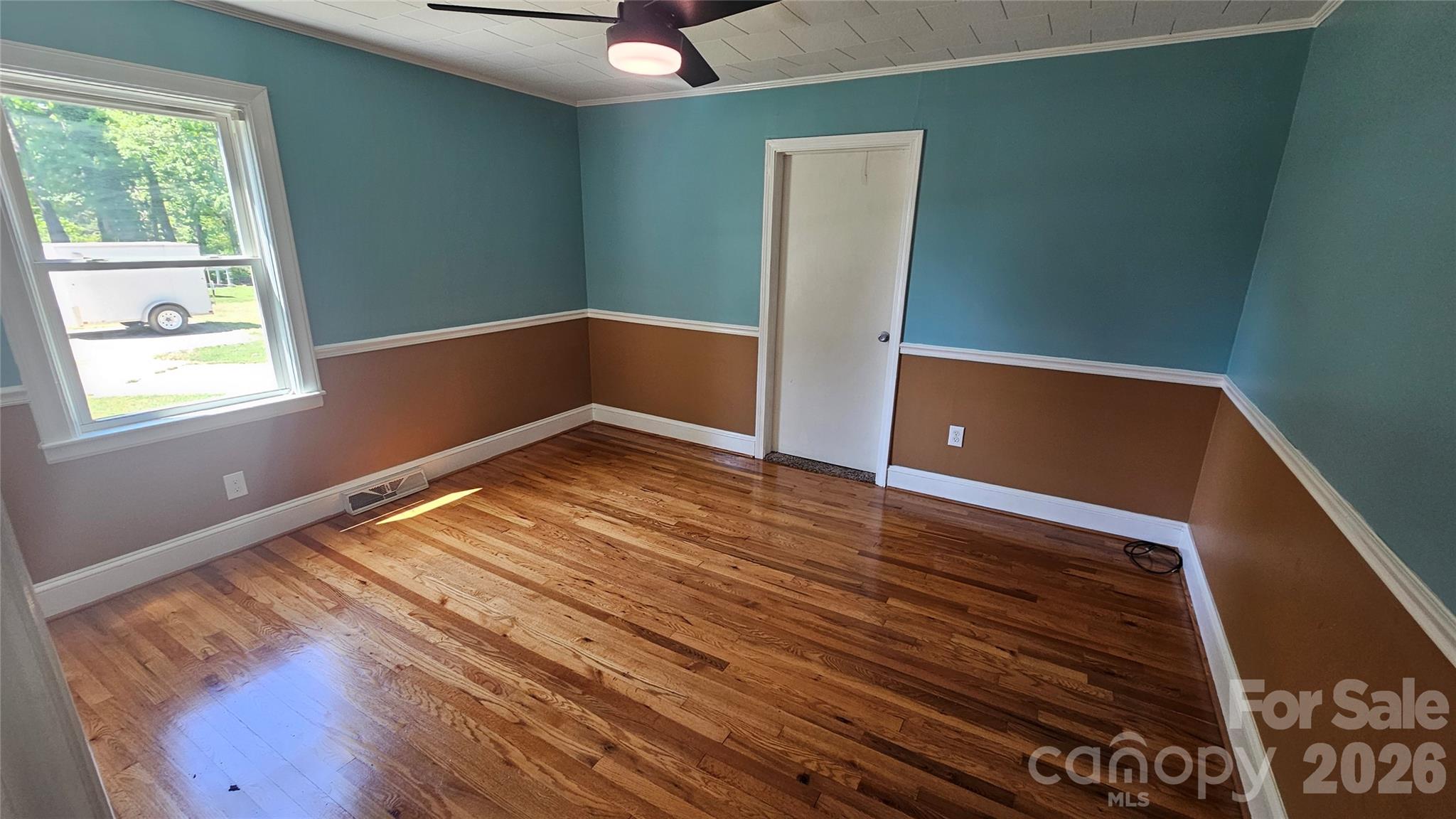 130 Pine State Road Troutman, NC 28166 - Photo 17 of 21 a view of an empty room with wooden floor and a window