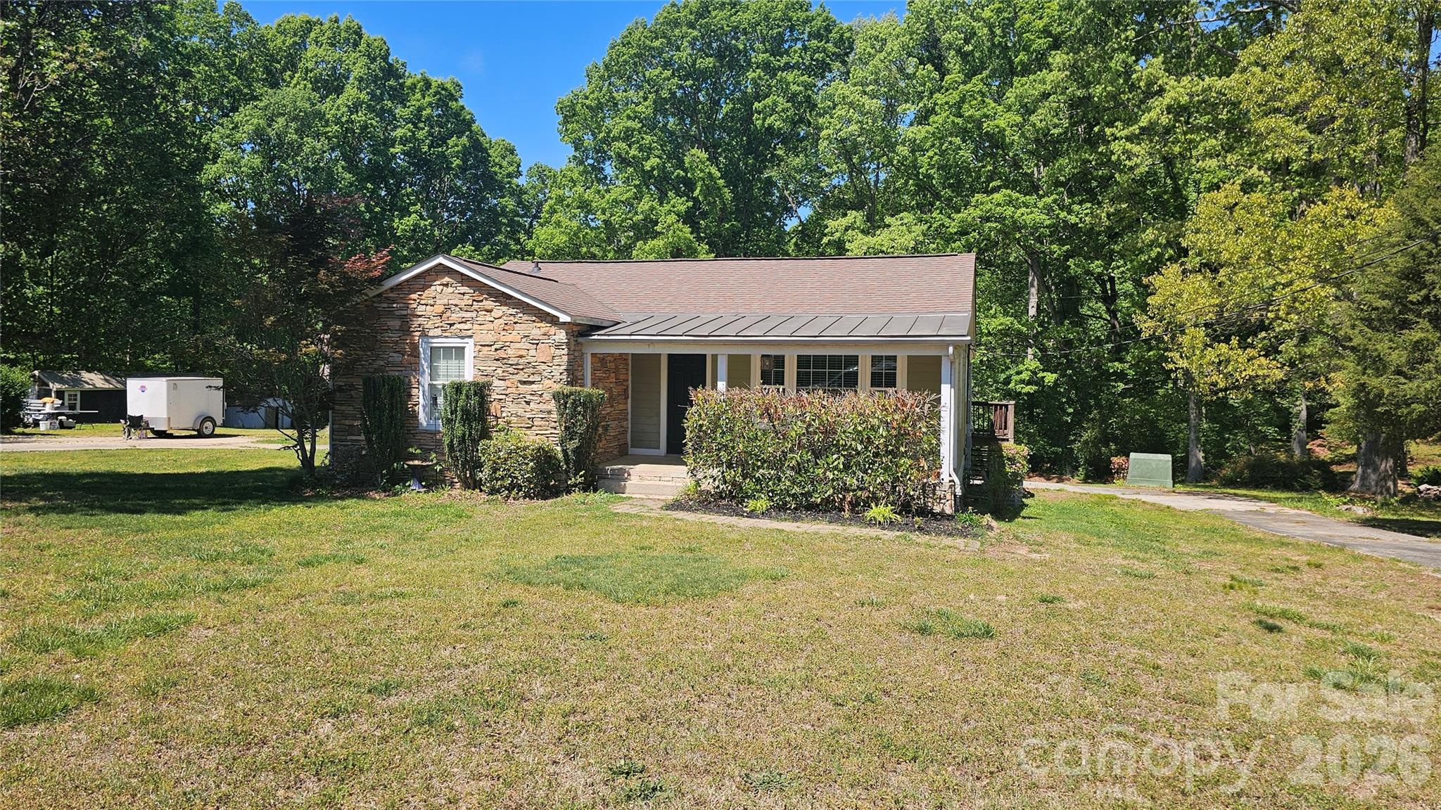 130 Pine State Road Troutman, NC 28166 - Photo 2 of 21 a front view of a house with a yard garage and outdoor seating