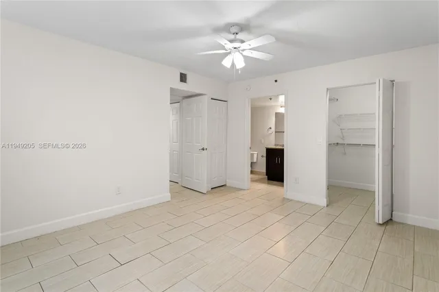 a view of an empty room with a ceiling fan