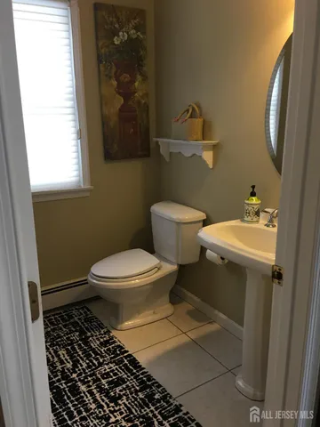a bathroom with a toilet a sink and a mirror