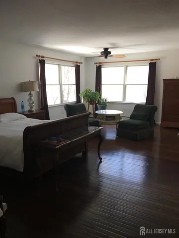 a living room with furniture windows and a wooden floor