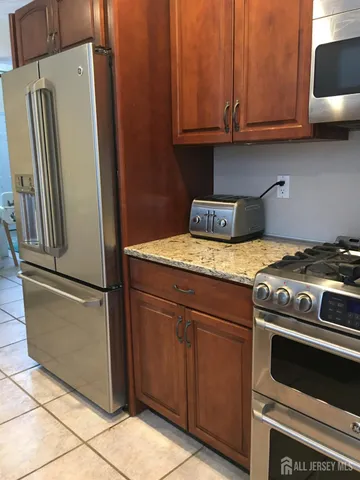 a kitchen with a stove and a refrigerator