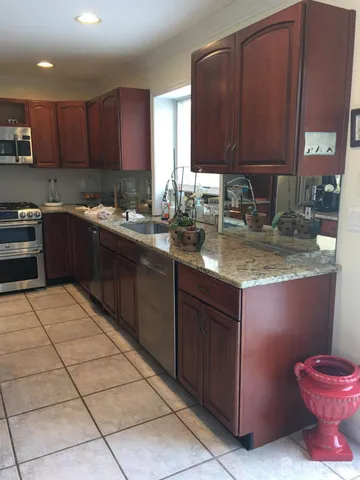 a kitchen with a sink a stove and cabinets