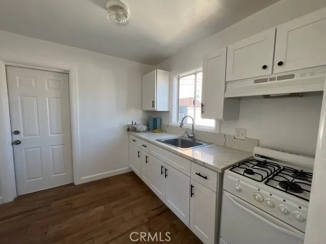 a kitchen with sink cabinets and stove