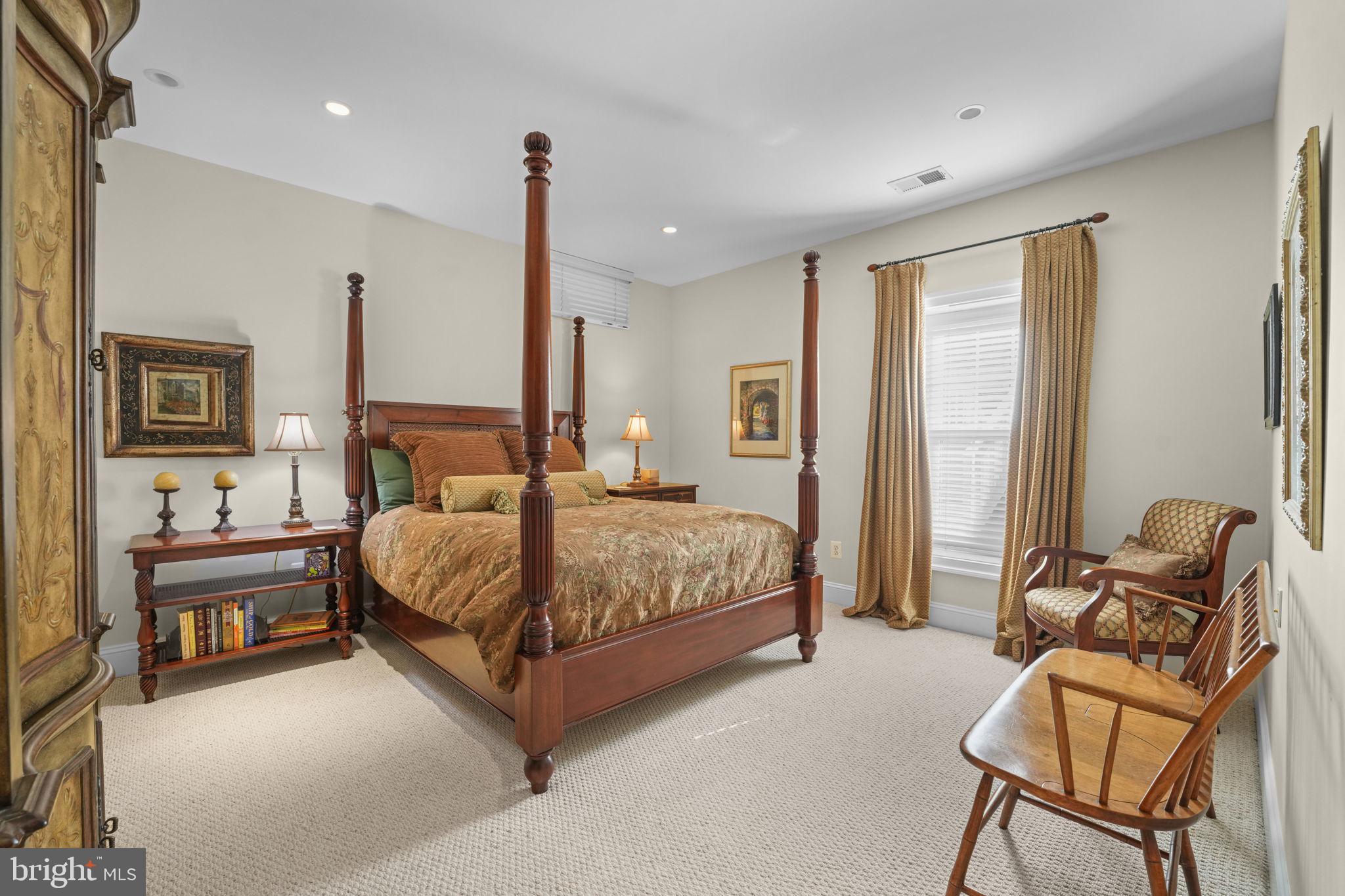 11431 Woolington Road Great Falls, VA 22066 - Photo 42 of 49 a bedroom with a bed and chair
