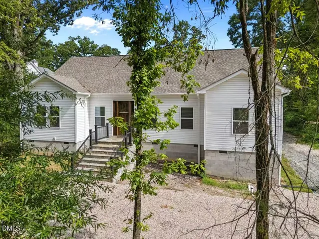 a house that has a tree in front of the house