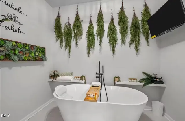 a white bath tub sitting next to a sink