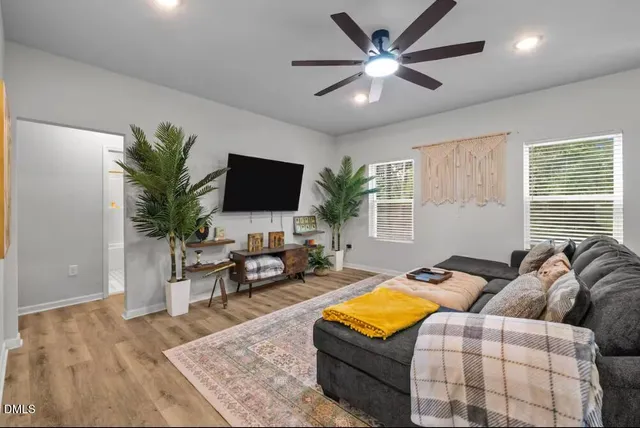 a living room with furniture and a flat screen tv