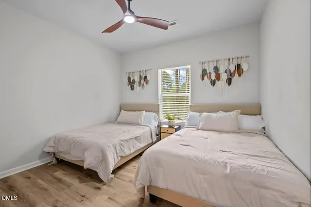 a bedroom with two beds and a window