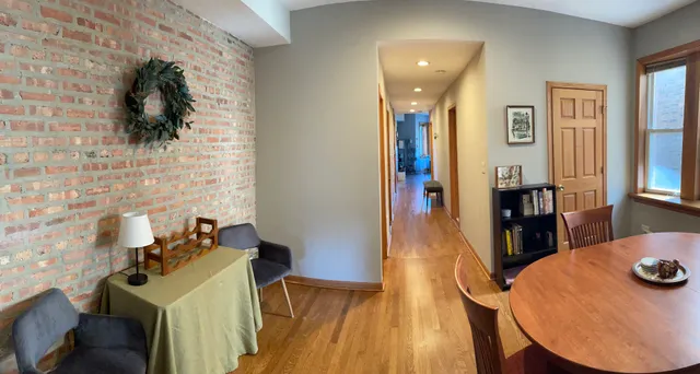 a view of a living room with furniture and wooden floor