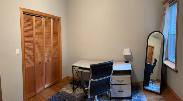 a view of a workspace with furniture and wooden floor