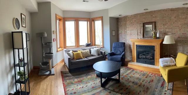 a living room with furniture fireplace and a table