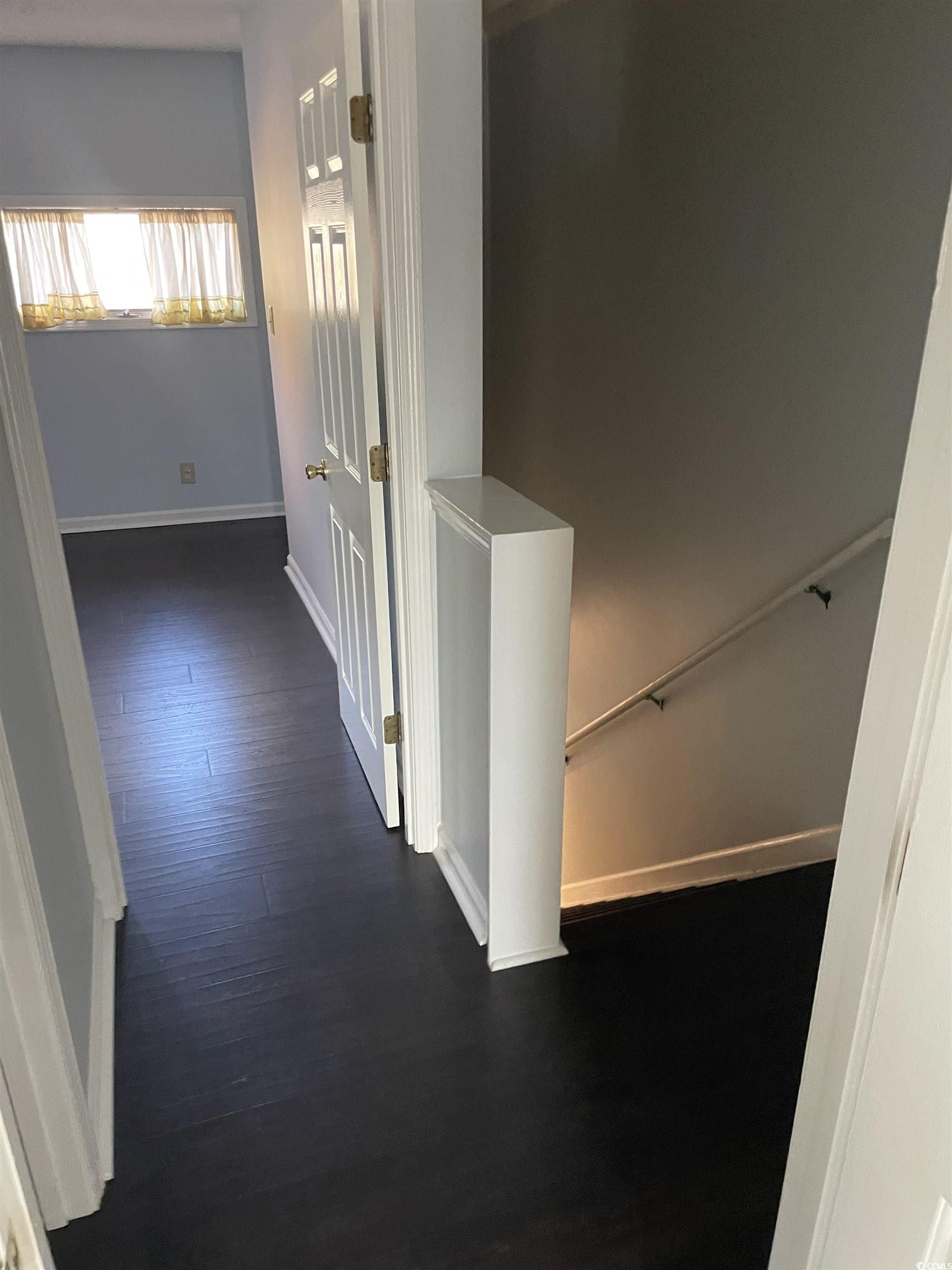 1851 Fairway Ridge Drive, Unit 7E Surfside Beach, SC 29575 - Photo 18 of 29 Hallway with dark wood-type flooring and stairway