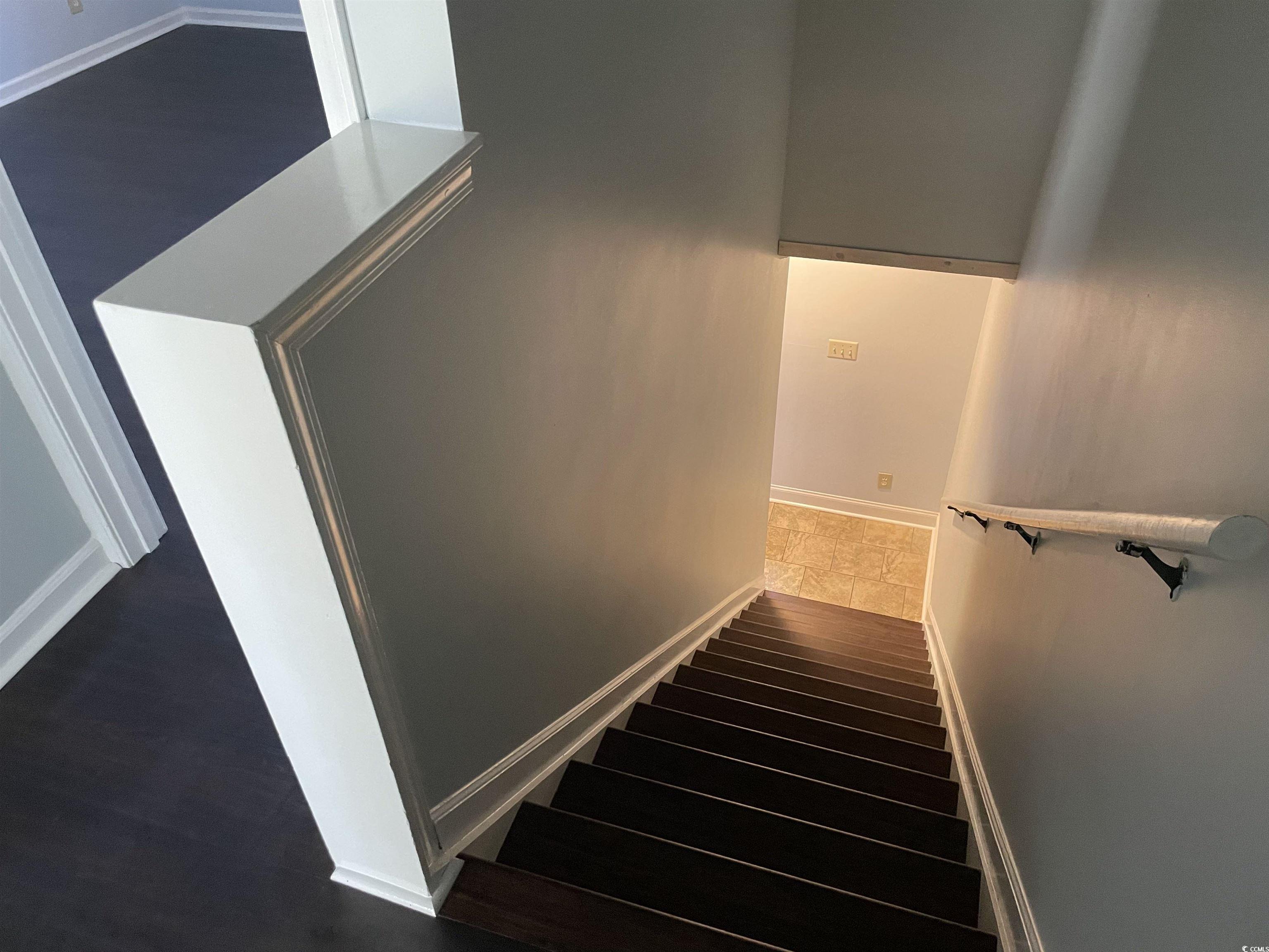 1851 Fairway Ridge Drive, Unit 7E Surfside Beach, SC 29575 - Photo 19 of 29 Stairway with baseboards and wood finished floors