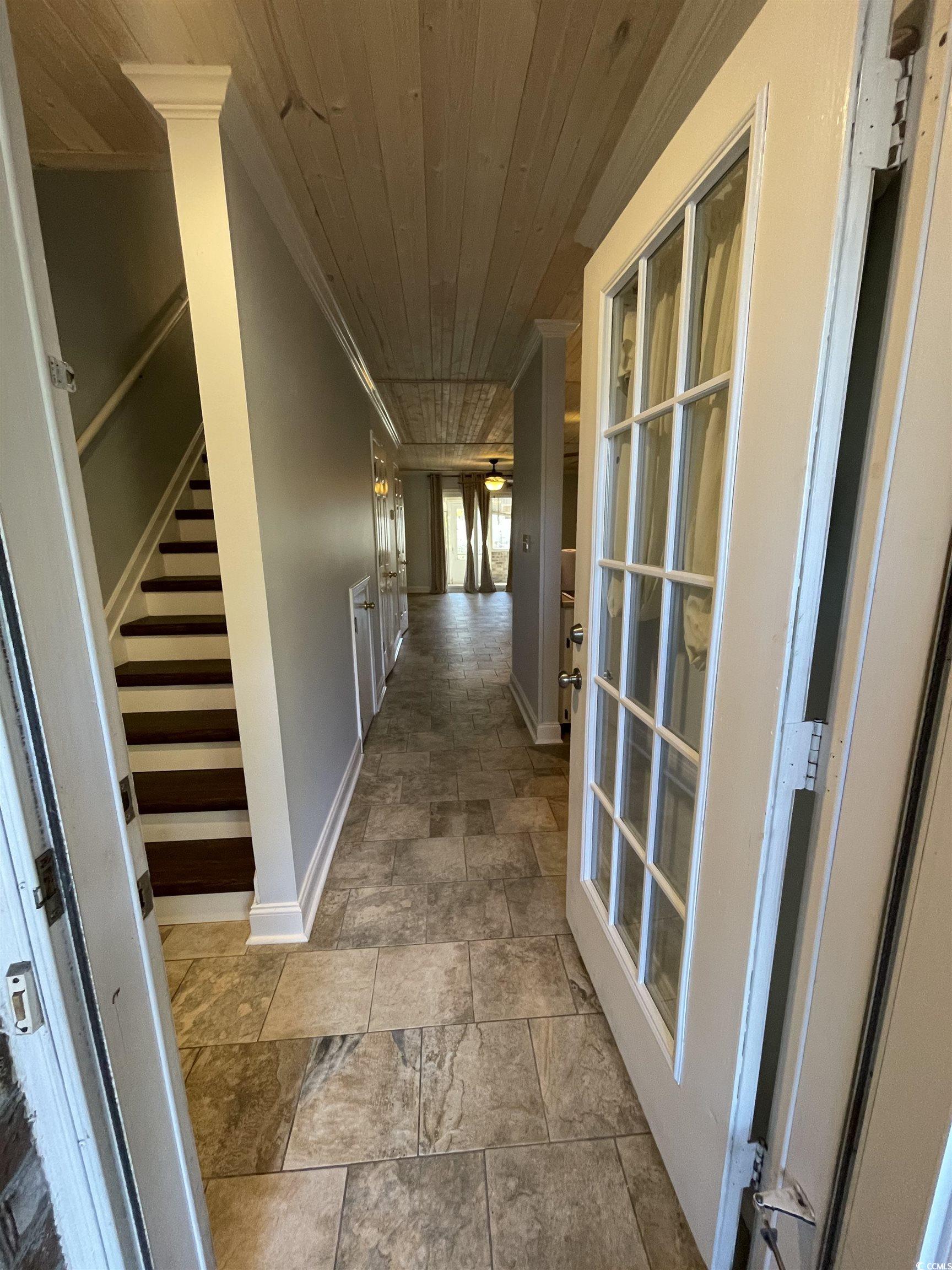 1851 Fairway Ridge Drive, Unit 7E Surfside Beach, SC 29575 - Photo 2 of 29 Hallway with stairs, stone finish floors, wooden ceiling, and ornamental molding