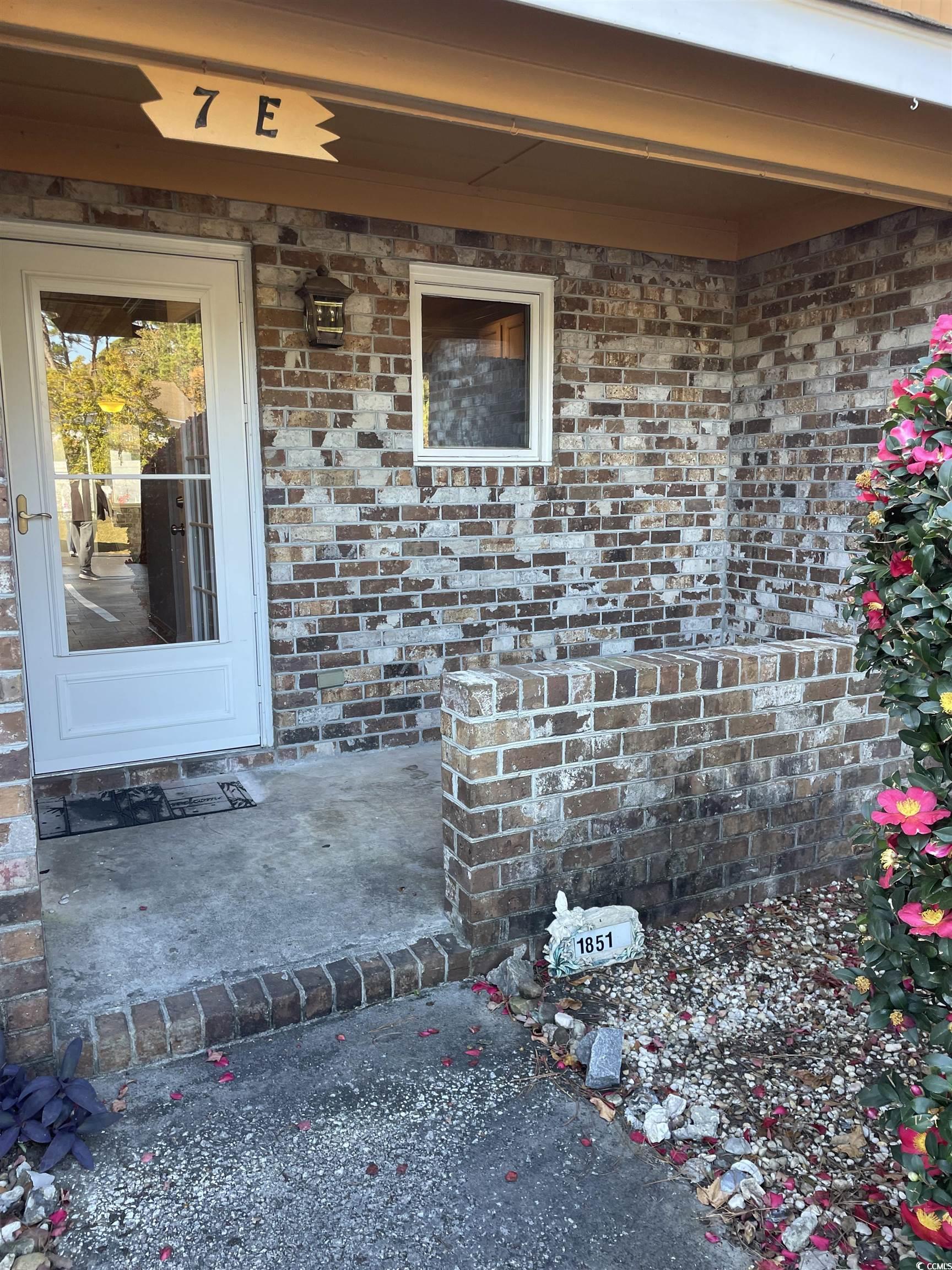 1851 Fairway Ridge Drive, Unit 7E Surfside Beach, SC 29575 - Photo 23 of 29 Entrance to property featuring brick siding