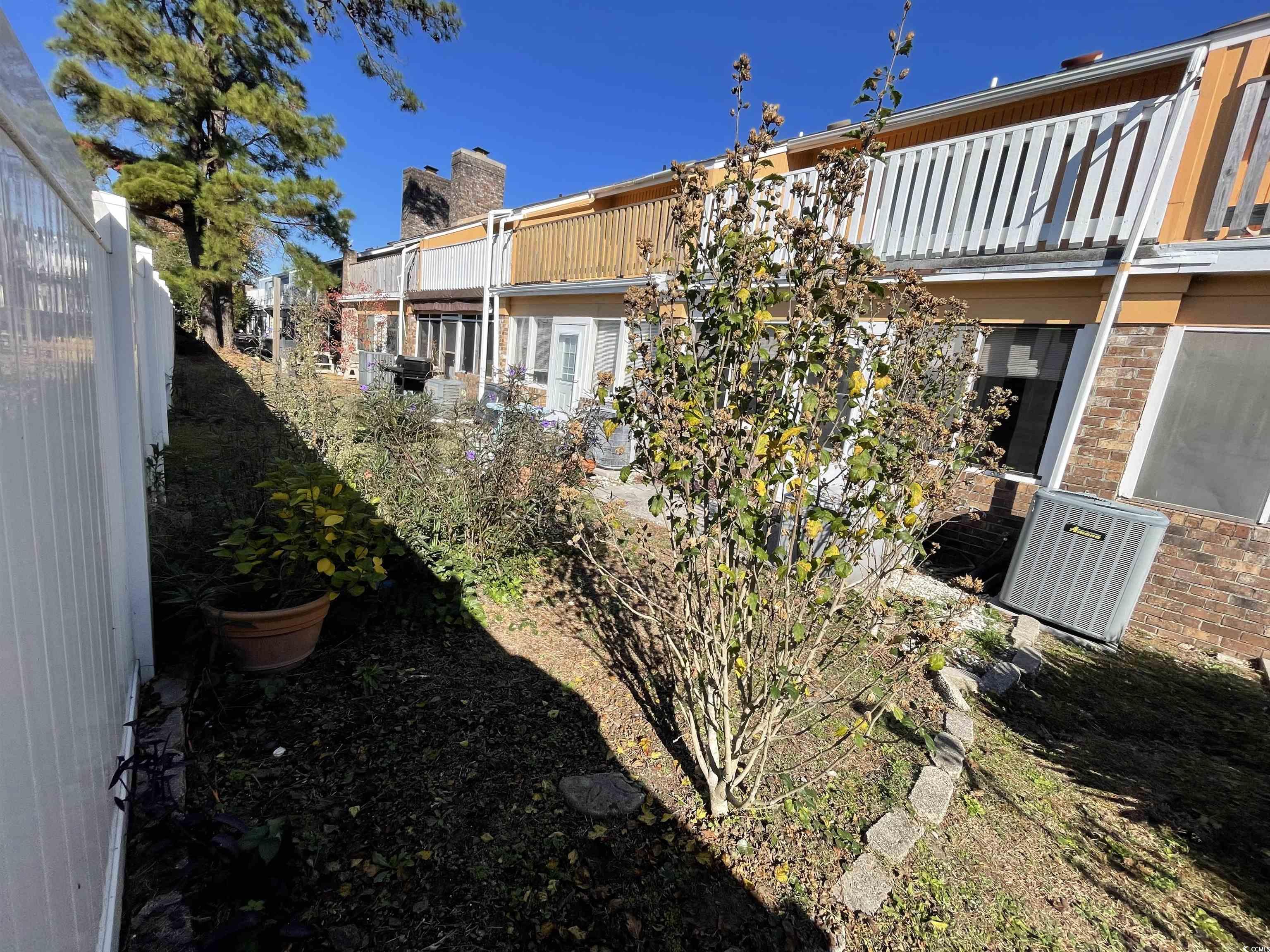 1851 Fairway Ridge Drive, Unit 7E Surfside Beach, SC 29575 - Photo 26 of 29 View of yard featuring a balcony