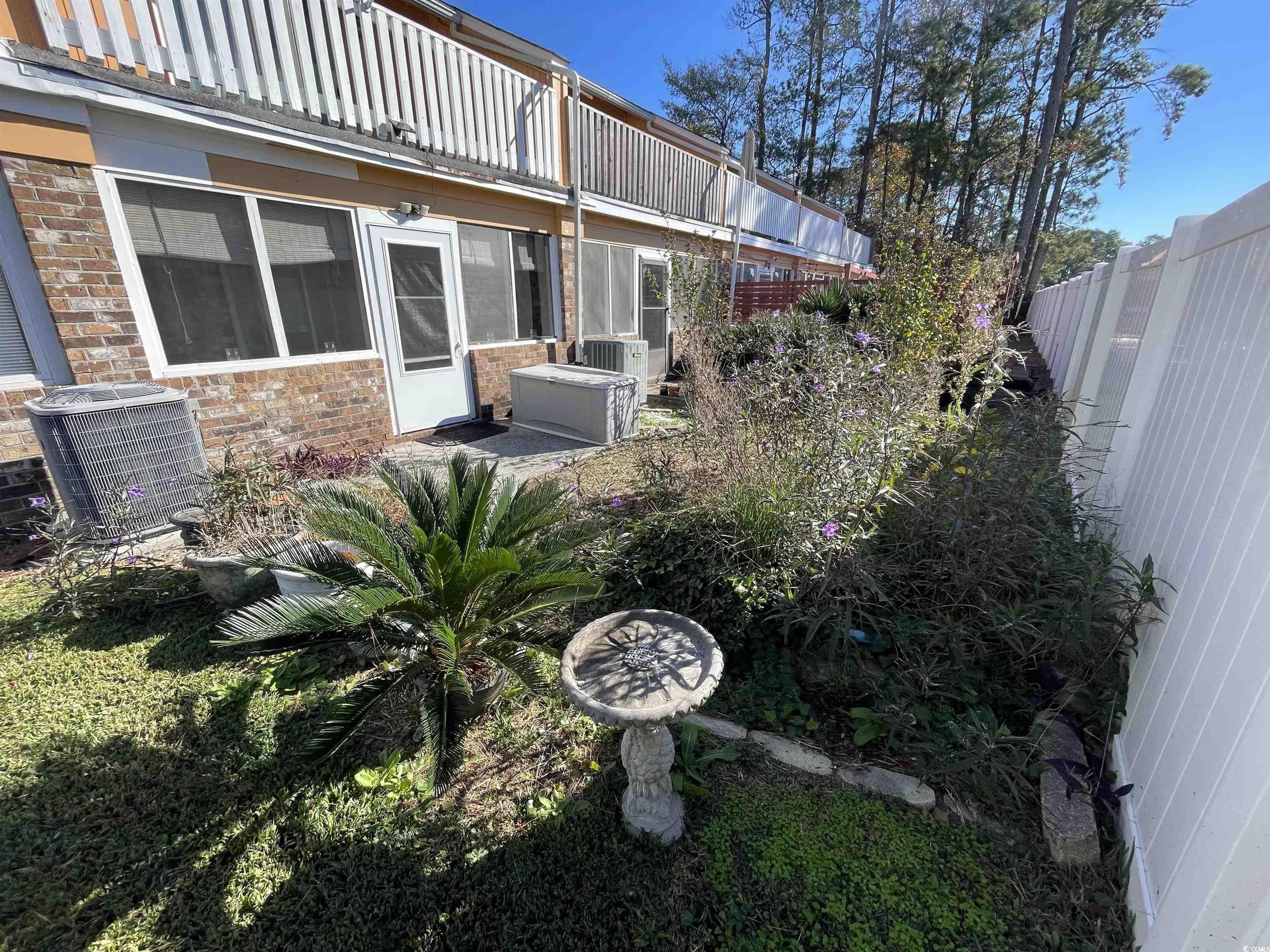 1851 Fairway Ridge Drive, Unit 7E Surfside Beach, SC 29575 - Photo 28 of 29 View of yard with a sunroom
