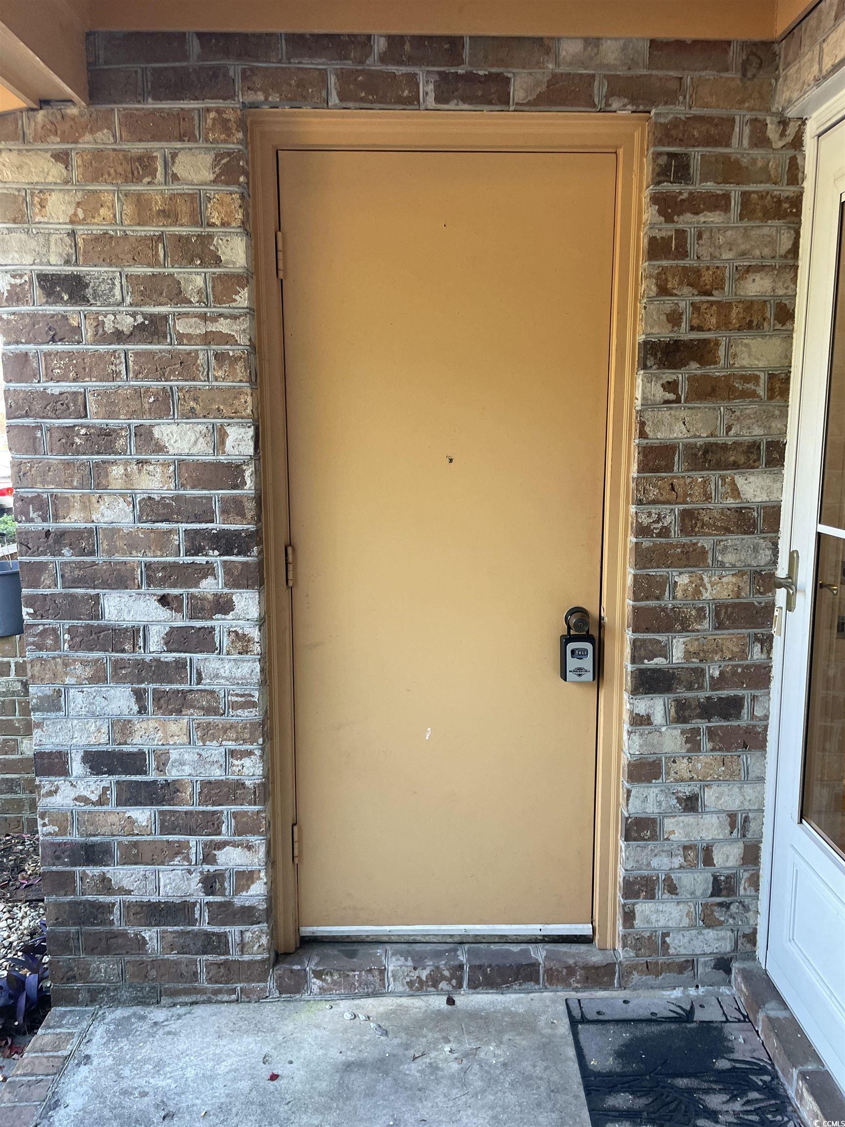 1851 Fairway Ridge Drive, Unit 7E Surfside Beach, SC 29575 - Photo 29 of 29 Property entrance featuring brick siding