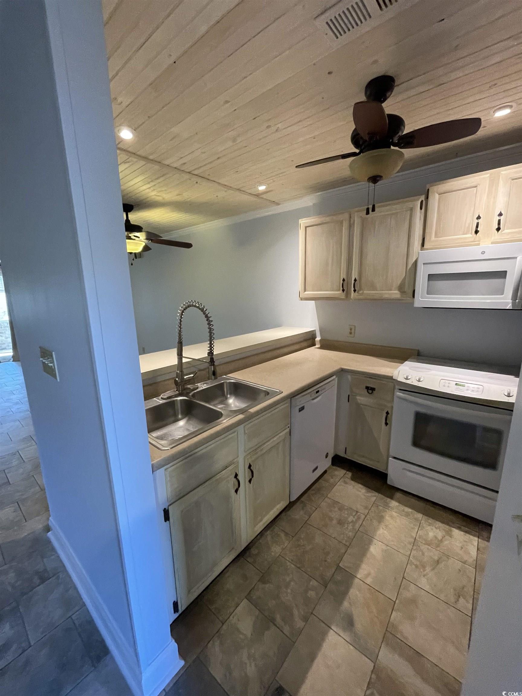 1851 Fairway Ridge Drive, Unit 7E Surfside Beach, SC 29575 - Photo 3 of 29 Kitchen with wooden ceiling, white appliances, recessed lighting, ceiling fan, and light brown cabinets