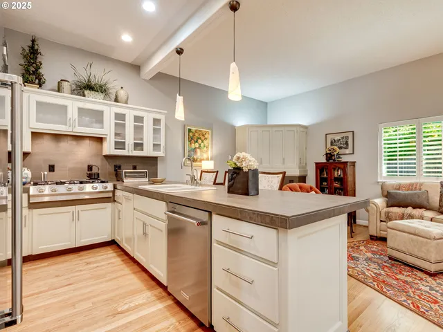 a kitchen with stainless steel appliances granite countertop a refrigerator and a sink