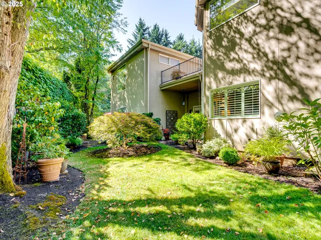 a view of a hallway with wooden floor and windows