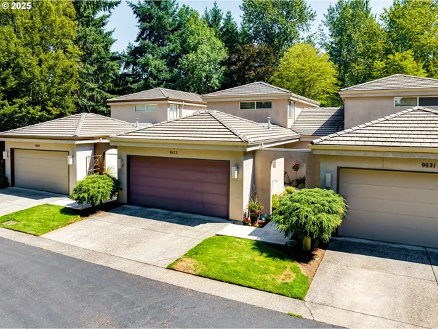 a front view of a house with a garden and plants