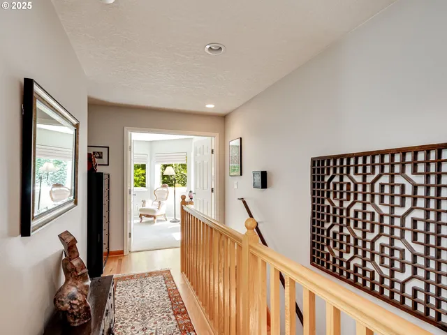 a bedroom with a bed and a painting on the wall