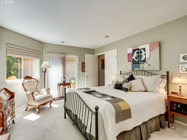 a bedroom with a bed and a dresser next to a window