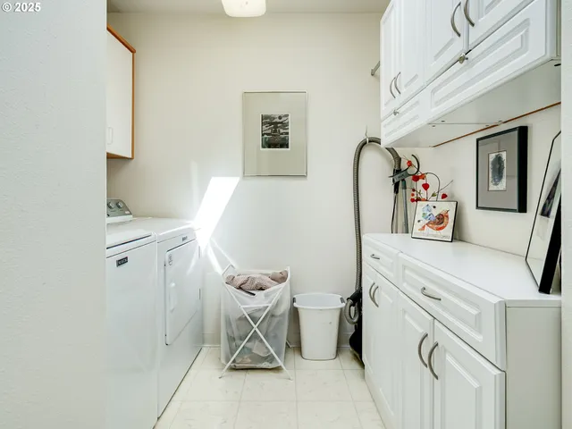 an aerial view of a house with a yard and large trees