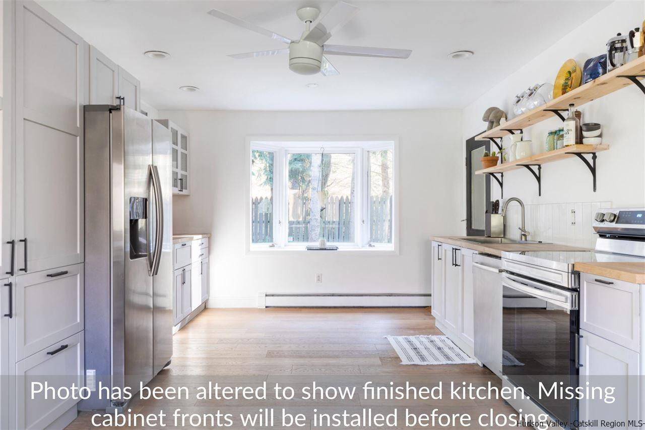1882 County Road Olivebridge, NY 12461 - Photo 14 of 35 a spacious bathroom with a granite countertop sink a large mirror and a shower