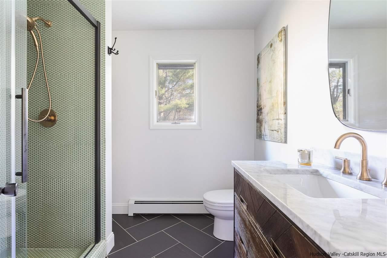 1882 County Road Olivebridge, NY 12461 - Photo 18 of 35 a bathroom with a granite countertop sink toilet and shower