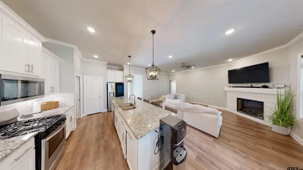 a living room with furniture a fireplace and a television