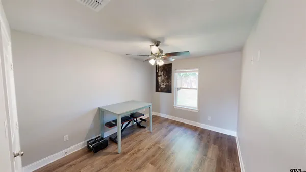 an empty room with windows and wooden floor