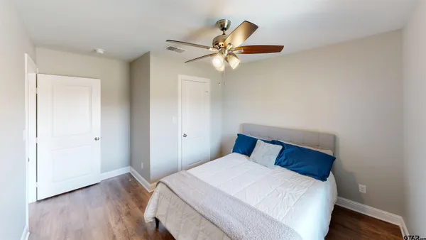 a bedroom with a bed and a chandelier