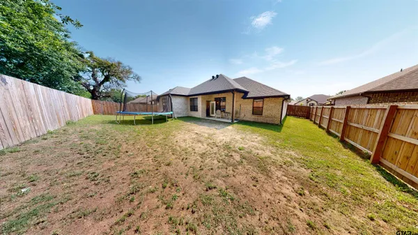 a house with tall trees in the background