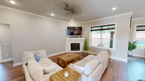 a living room with furniture fireplace and window