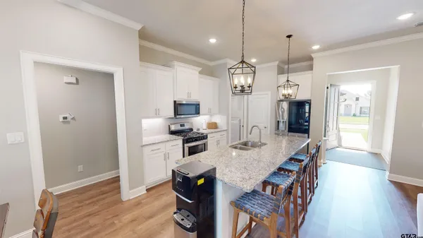 a large kitchen with a table and chairs