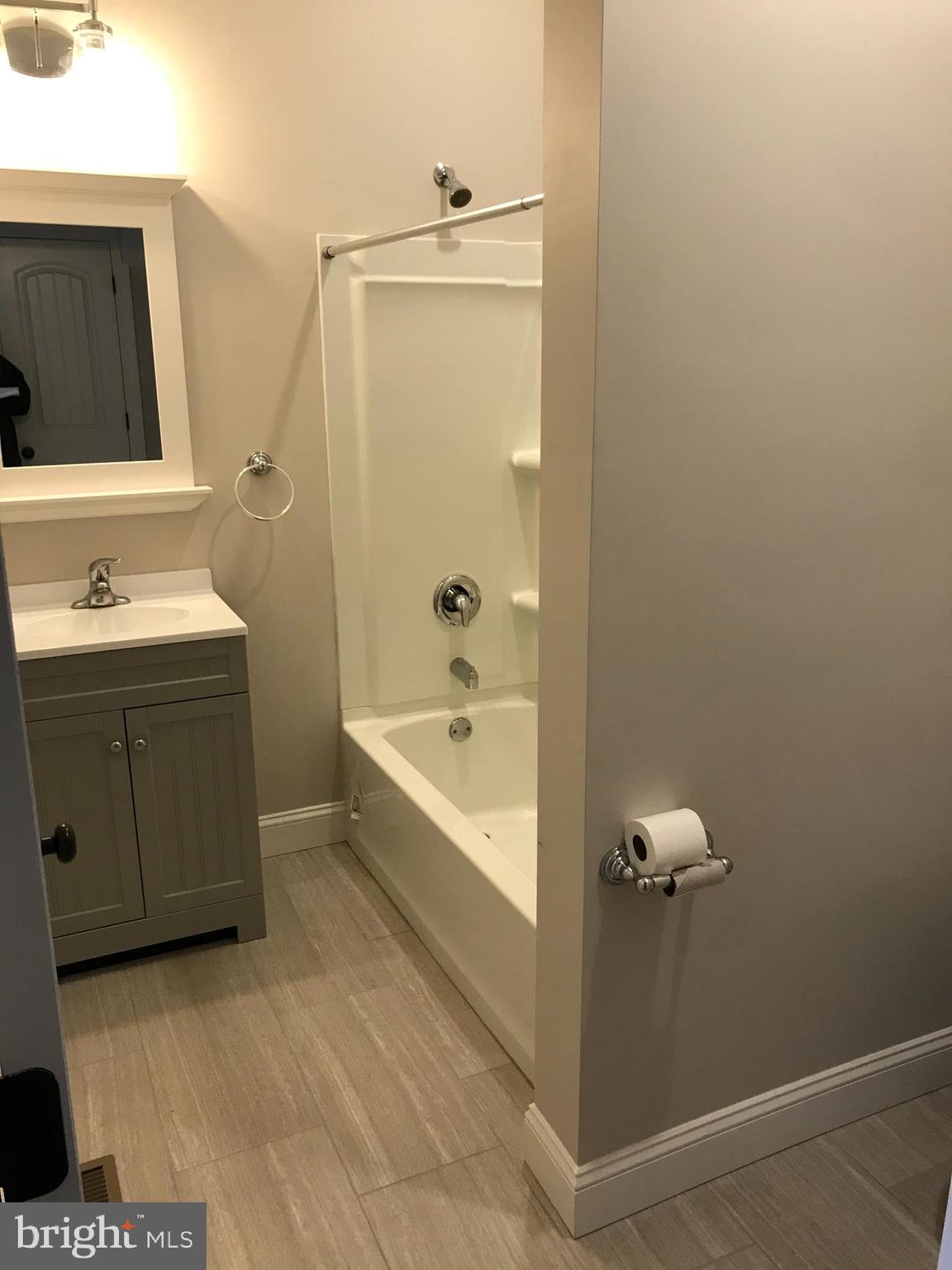 15 A Potter Street Haddonfield, NJ 08033 - Photo 4 of 11 a bathroom with a tub sink and mirror
