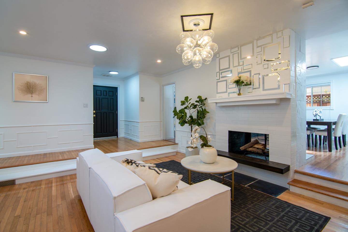 535 Sobrato Drive Campbell, CA 95008 - Photo 6 of 32 a living room with furniture a chandelier and a fireplace
