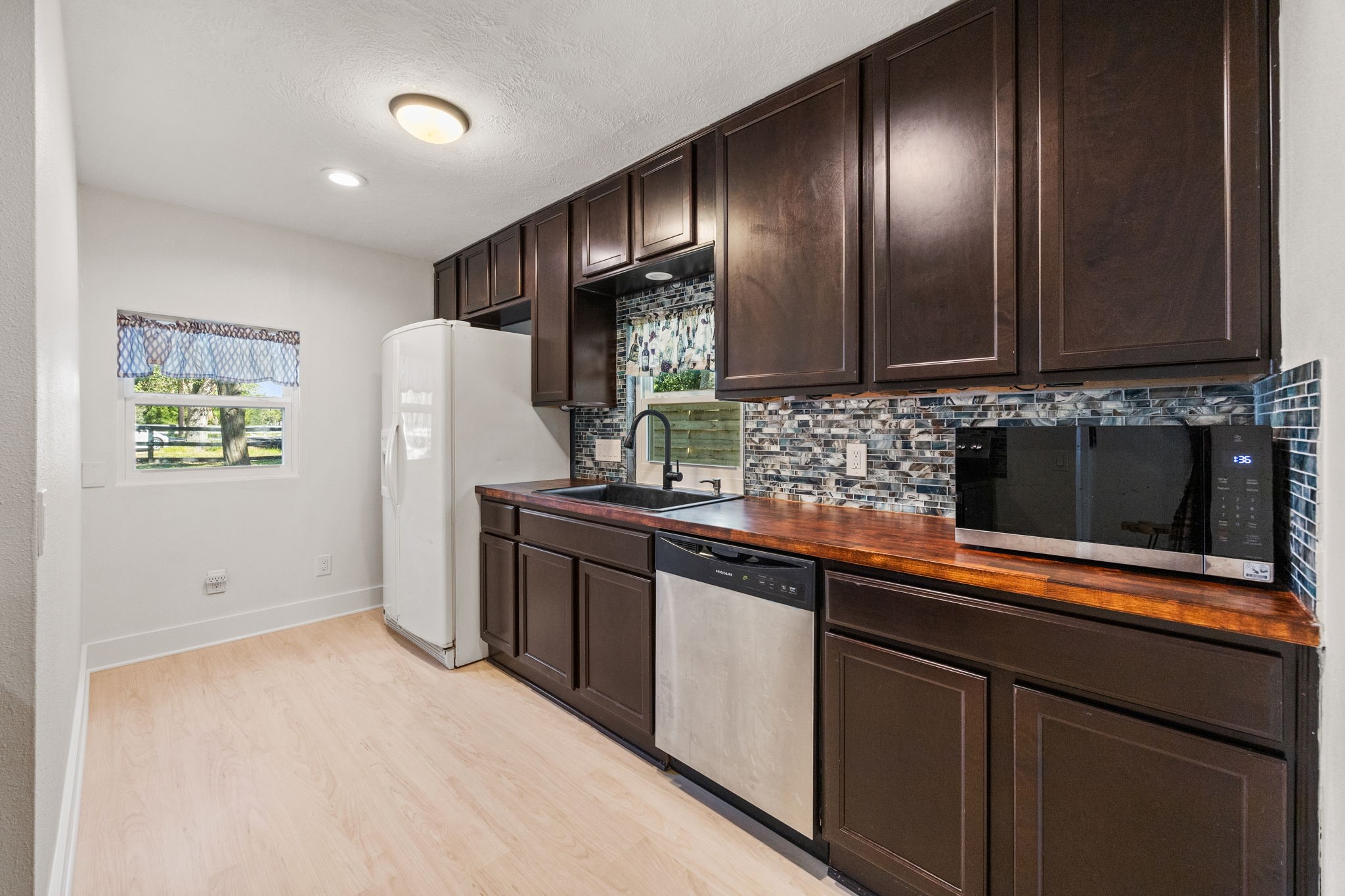2693 Fairview Road Alvin, TX 77511 - Photo 30 of 49 a kitchen with stainless steel appliances granite countertop a refrigerator and a sink