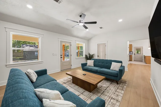 a living room with furniture and a flat screen tv