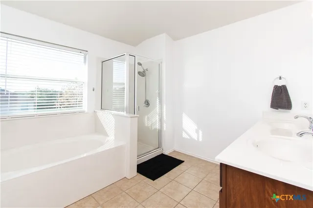 a bathroom with a bathtub and a sink